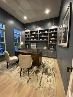 an office with gray walls and wooden floors