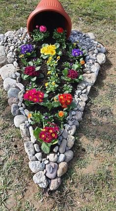 there is a flower bed made out of rocks