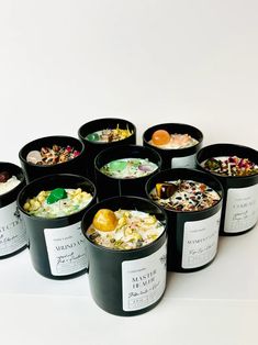 six black buckets filled with different types of food