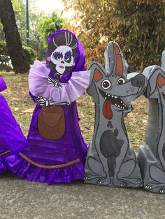 three paper mache figurines sitting on the ground