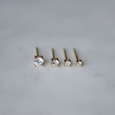 Simple, and elegant these studs are perfect for a minimalist, chic look. Dainty studs made of highest grade cubic zirconia for an authentic diamond look! - - D E T A I L S - - ▪️ Made of 925 Sterling Silver ▪️ Thick plating of 14k Gold or Rhodium ▪️ Available in 4mm, 3mm, 2.5mm and 2mm sizes ▪️ Sold as a pair ▪️ Nickel-free and hypoallergenic Comes in a cute, white gift box, ready for gift-giving! Made with 100% Pure Love ♡ Tragus Stud, Cartilage Stud, Dainty Studs, Solitaire Studs, Minimalist Chic, Tiny Studs, Tiny Stud Earrings, Demi Fine Jewelry, Diamond Stud Earrings