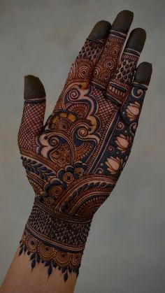 a person's hand is decorated with hennap and intricate designs on it