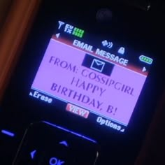 a cell phone with a message on the screen that says from gossipgirl happy birthday