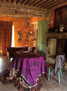 a dining room with a table and chairs in front of a fire place next to a fireplace