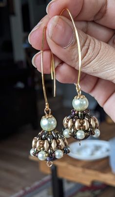 These are Indian style jewelries called Jhumka. Every single piece is handmade by me using high quality product such as beads from Miyuki, some hoops are 14 to 18 carat gold plated (the ones studded with zirconia diamond crystals), crystals are mainly from Czech from Periciosa. The  green bicone crystal Jhumka in this listing and the bronze pearl inside the bronze Jhumka are all Swarovski products. I buy the Swarovski gems from a major wholesalers here in Vancouver BC. Please note the hoop style Gold Jewelry With Dangling Beads For Anniversary, Anniversary Gold Jewelry With Dangling Beads, Handmade Fusion Dangle Jhumkas, Handmade Fusion Style Dangle Jhumkas, Round Brass Jhumkas As Gift, Handmade Fusion Jhumkas, Gold Earrings With Spacer And Round Beads, Gold Hoop Earrings With Spacer Beads, Handmade Fusion Style Jhumkas