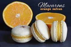 macarons orange satinan are arranged next to an orange slice and one is cut in half