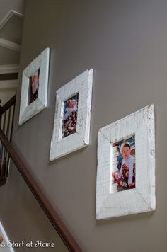 three frames are hanging on the wall next to a stair case with pictures in them