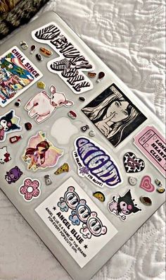 an assortment of stickers and decals on a bed