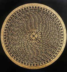 an intricate gold and black plate on a black background