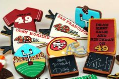 decorated cookies are arranged in the shape of football jerseys and numbers, with chalkboards on them