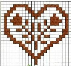 a cross - stitch heart is shown in brown and white