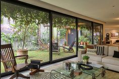 a living room filled with furniture and lots of windows