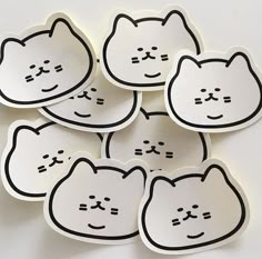 six stickers with black and white cats drawn on the back of them, all in different shapes