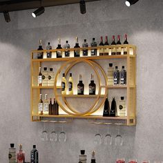 a wall mounted wine rack filled with lots of bottles and glasses on top of a counter