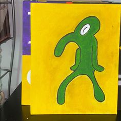 a yellow and green painting with a person on it's face in the center