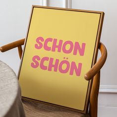 a wooden chair with a yellow sign that says schon - schon on it