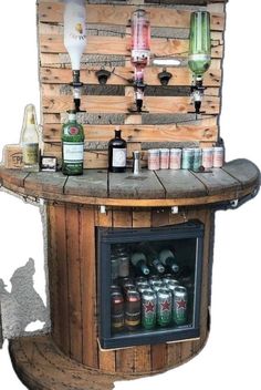 an outdoor bar made out of wooden pallets with bottles and cans on the top