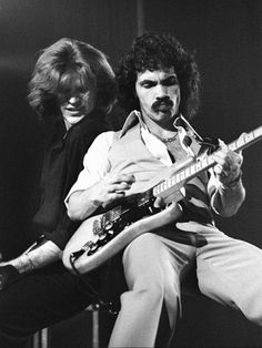 two men playing guitars on stage with the caption kiss on my list hall & oates