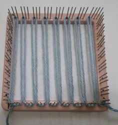 several blue and white needles are in a wooden tray