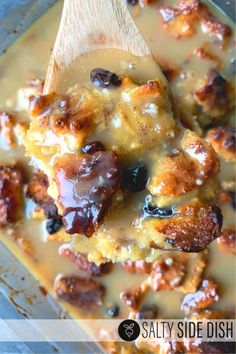 a wooden spoon with some kind of food in it on top of a pan filled with pudding