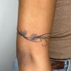 a woman's arm with a tattoo design on the left side of her arm