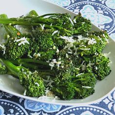 broccoli florets with shredded parmesan cheese in a white bowl