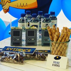 some snacks are sitting on a table next to bottles of water