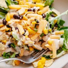 a white plate topped with salad and chips