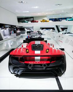 a red and white sports car in a showroom