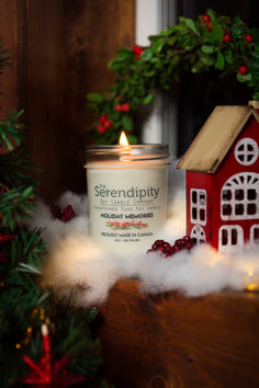 a candle sitting on top of a table next to a christmas tree