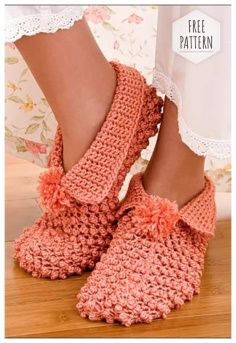 a woman's feet wearing pink crocheted slippers on top of a wooden floor