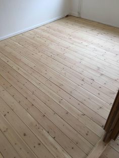 an empty room with white walls and wood floors is seen in this image from the doorway