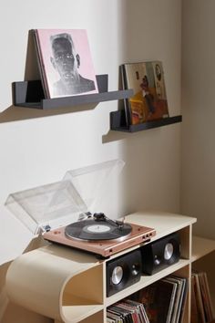 a record player is sitting on top of a shelf