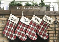 three stockings hanging from a fireplace in front of a sign that says, the scheneder family