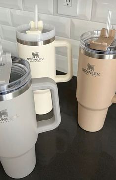 three coffee cups sitting on top of a counter