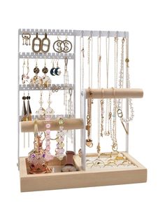 a jewelry rack with several necklaces and earrings on it's display shelf in front of a white background