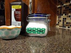 two glass jars sitting on top of a counter