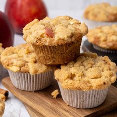 apple pie muffins on a cutting board with apples in the background