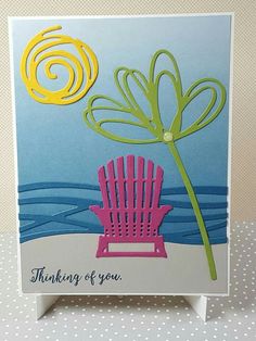 a handmade card with a pink chair and yellow flower on the beach, which reads thinking of you