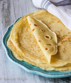 three tortillas on a blue plate with a white towel