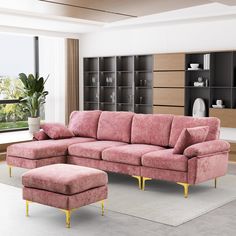 a living room with a pink couch and ottoman