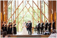 a bride and groom are standing at the alter in front of their wedding party,