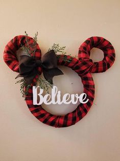 a mickey mouse wreath with the word believe painted on it