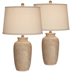 two ceramic lamps with beige shades on them