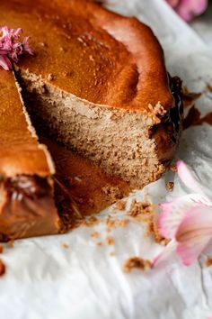 a close up of a cake on a piece of paper with one slice cut out