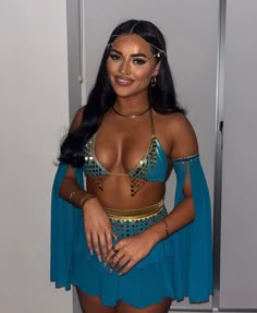 a woman in a blue outfit posing for the camera