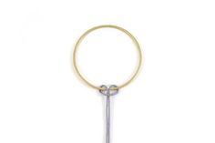 a gold and silver keychain with a metal loop hanging from it's end