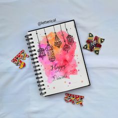 a spiral notebook with some magnets on it next to an assortment of other items