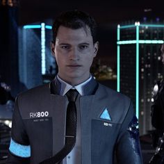 a man in a suit and tie standing next to another man wearing a futuristic outfit