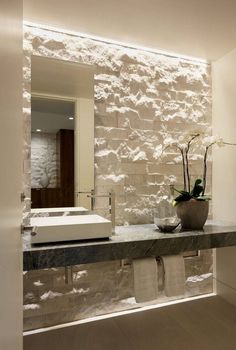 a bathroom with a sink, mirror and towel rack on the counter in front of it